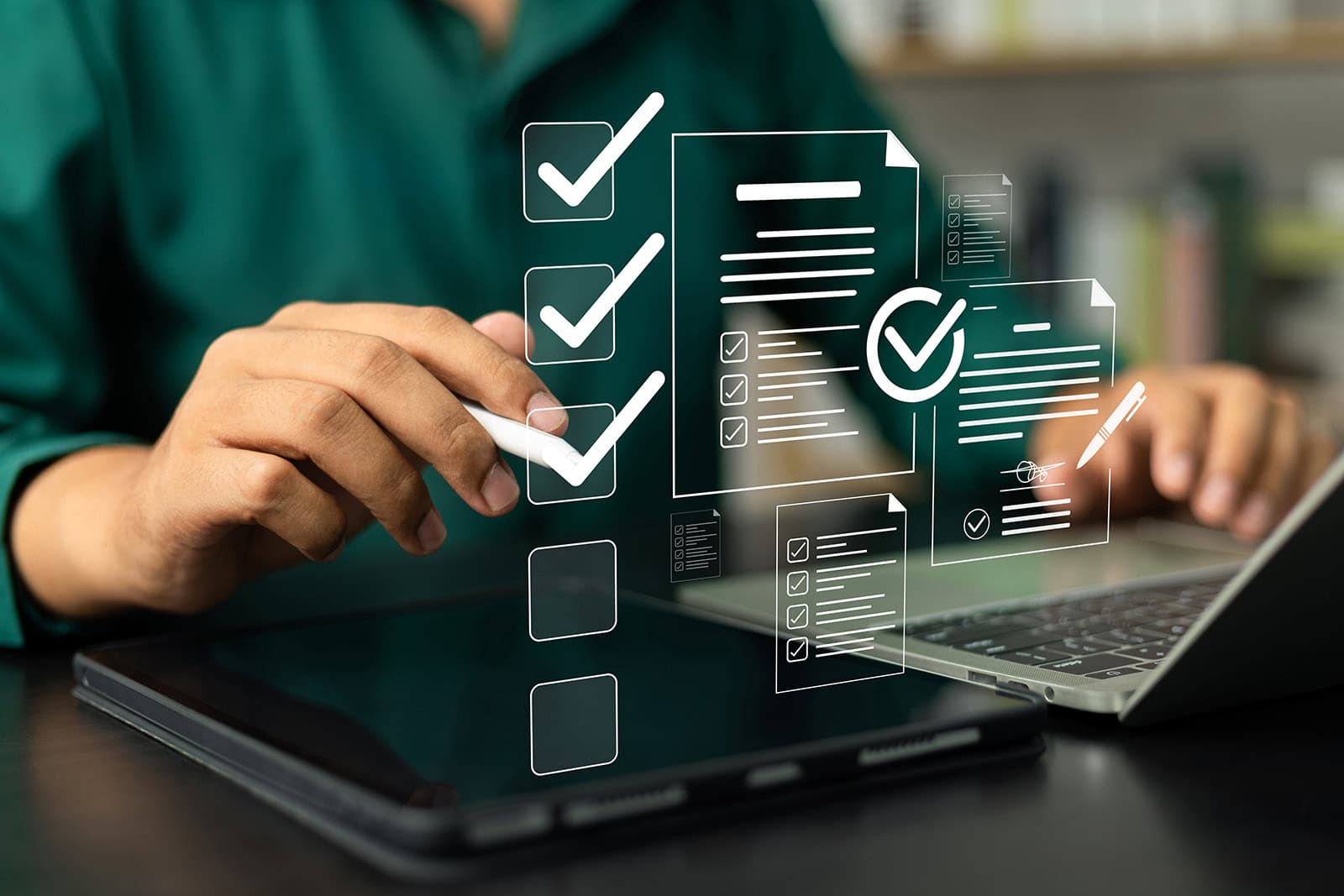 Dental professional working on a dental compliance checklist at a laptop.